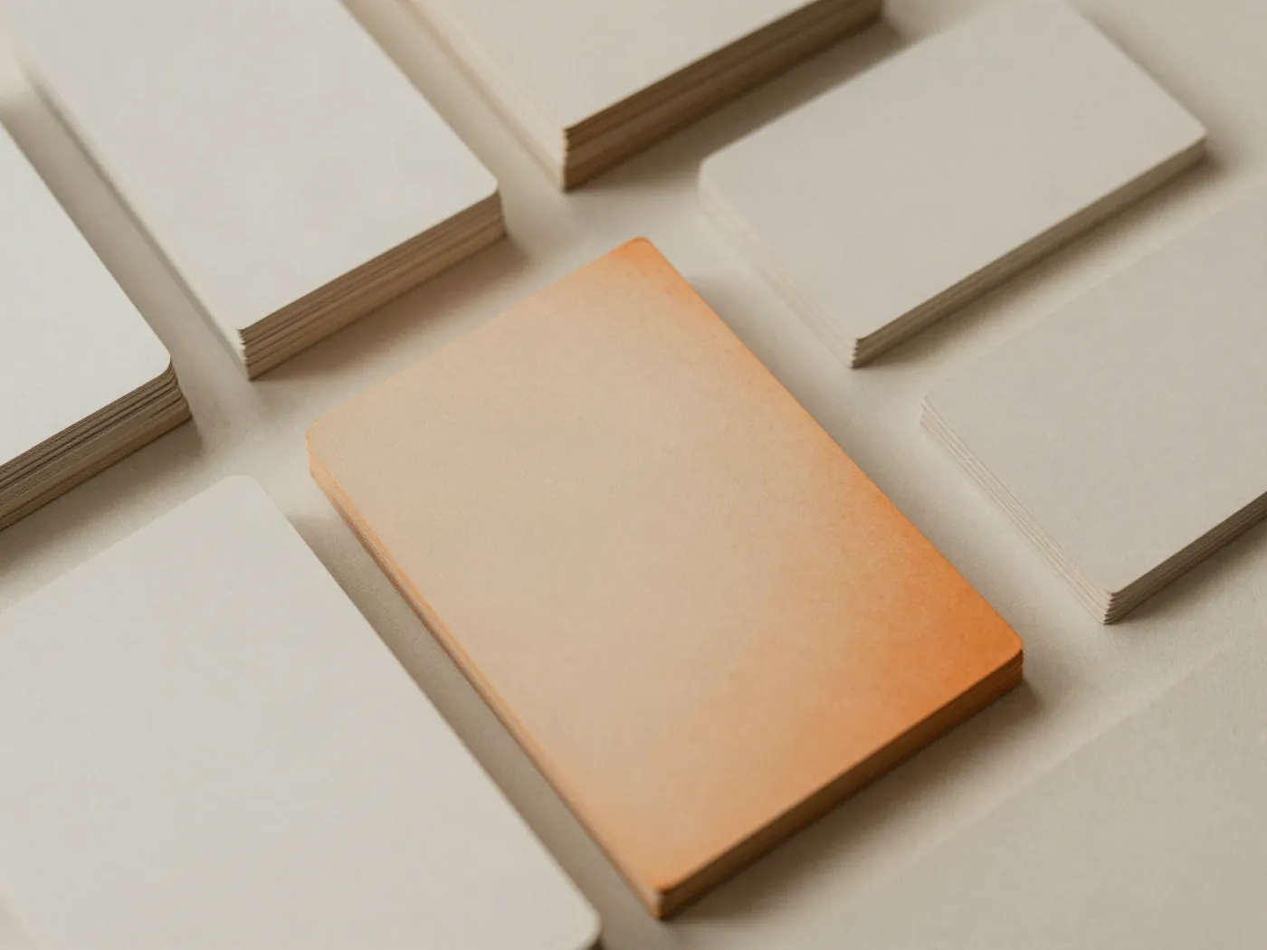 Neat stacks of blank record cards with one card in burnt orange.